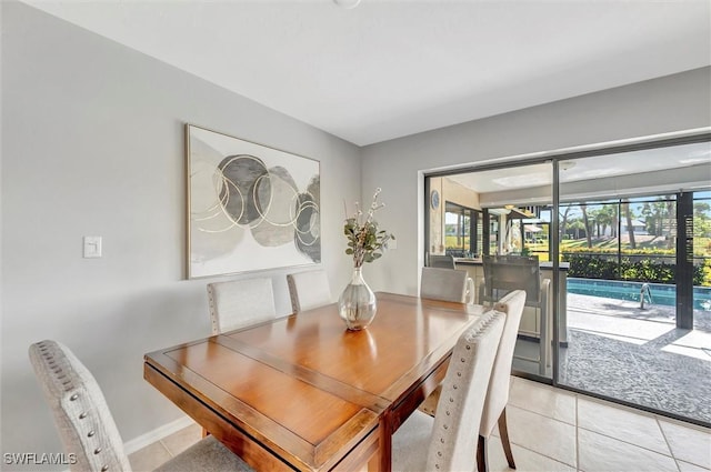 28389 Verde Ln, Bonita Springs, FL 34135 - dining area featuring light tile patterned floors and baseboards
