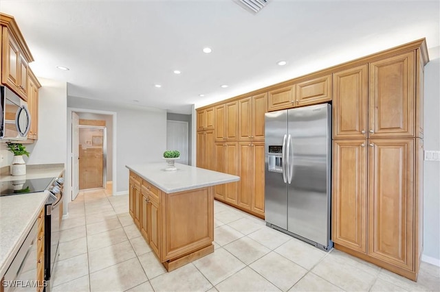 28389 Verde Ln, Bonita Springs, FL 34135 - kitchen with appliances with stainless steel finishes, a center island, light countertops, light tile patterned floors, and recessed lighting