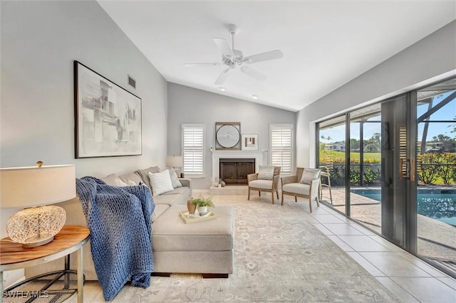 28389 Verde Ln, Bonita Springs, FL 34135 - living room featuring vaulted ceiling, light tile patterned floors, ceiling fan, and a fireplace with raised hearth