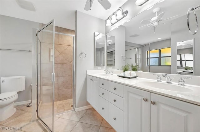 28389 Verde Ln, Bonita Springs, FL 34135 - full bathroom with a ceiling fan, toilet, double vanity, a stall shower, and tile patterned floors