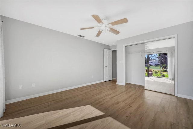 28389 Verde Ln, Bonita Springs, FL 34135 - unfurnished bedroom with wood finished floors, baseboards, a closet, and a ceiling fan