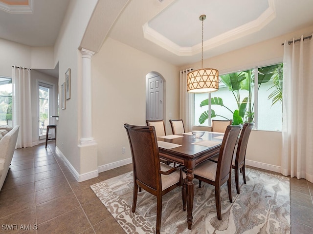 7826 Martino Cir, Naples, FL 34112 - dining area featuring a tray ceiling, baseboards, decorative columns, and arched walkways