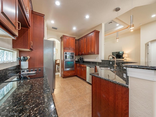 7826 Martino Cir, Naples, FL 34112 - kitchen with arched walkways, visible vents, a sink, and appliances with stainless steel finishes