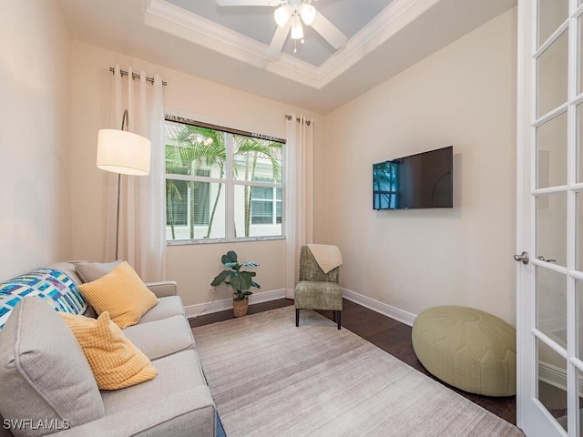 7826 Martino Cir, Naples, FL 34112 - living area featuring ornamental molding, baseboards, a raised ceiling, a ceiling fan, and wood finished floors