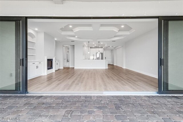 15328 Lucerna St Unit 103, Naples, FL 34114 - unfurnished living room featuring built in features, beamed ceiling, baseboards, and recessed lighting