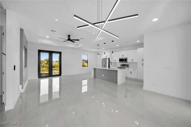 129 NE 5th Ter, Cape Coral, FL 33909 - living area with a tray ceiling, french doors, visible vents, ceiling fan, and recessed lighting