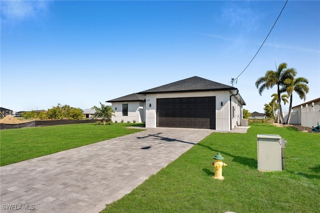 129 NE 5th Ter, Cape Coral, FL 33909 - view of front of property with a front yard, driveway, stucco siding, and a shingled roof