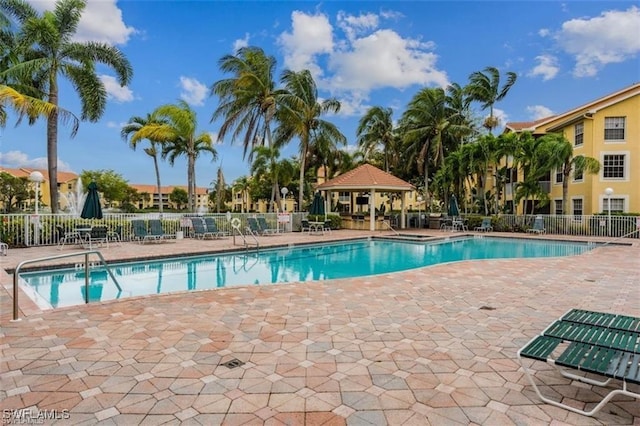 community pool featuring a gazebo, fence, and a patio