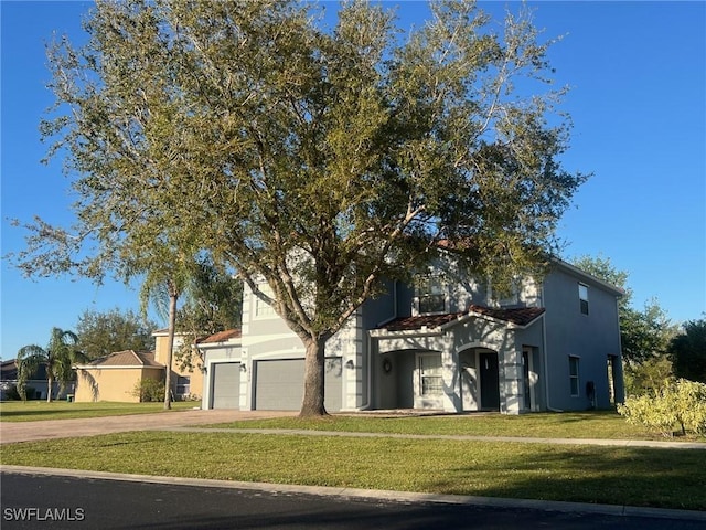 view of front of property featuring a front yard, stucco siding, and concrete driveway