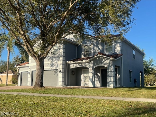 traditional home with a front lawn, driveway, stucco siding, and a garage