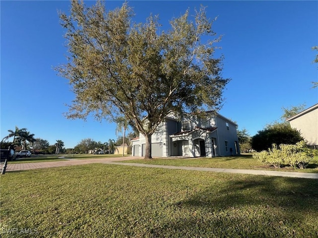 view of yard with driveway and a garage