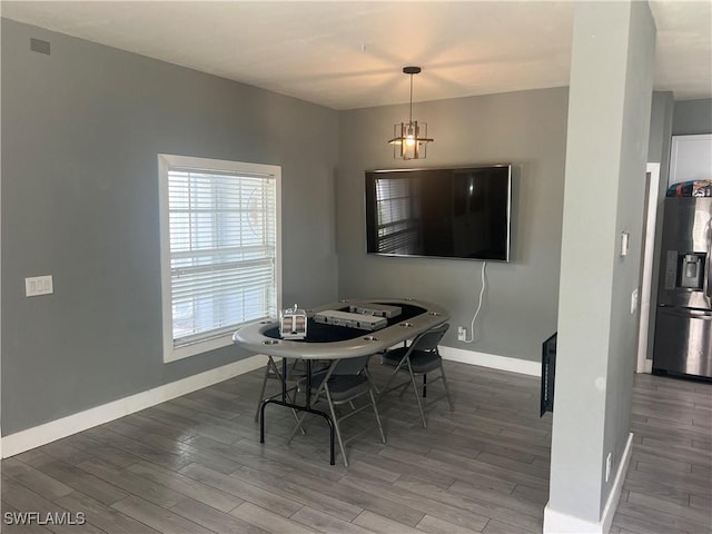 dining area featuring baseboards and wood finished floors