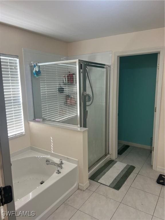 bathroom featuring a garden tub, a stall shower, and tile patterned flooring
