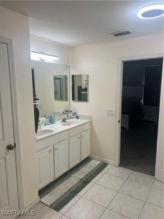 full bath featuring tile patterned flooring, a sink, double vanity, and visible vents