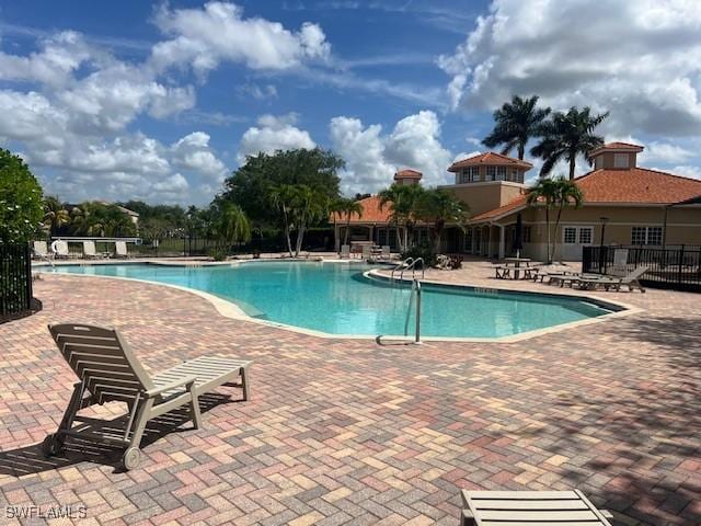 pool featuring fence and a patio