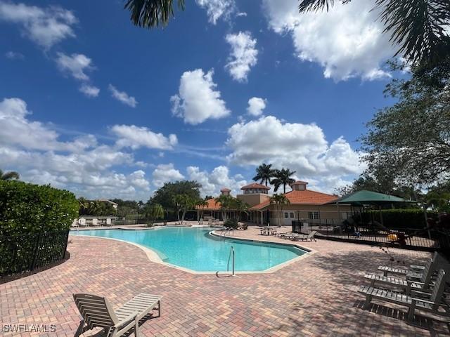 pool with fence and a patio area
