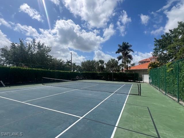 view of tennis court with fence
