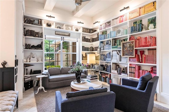 living area with tile patterned flooring and beam ceiling