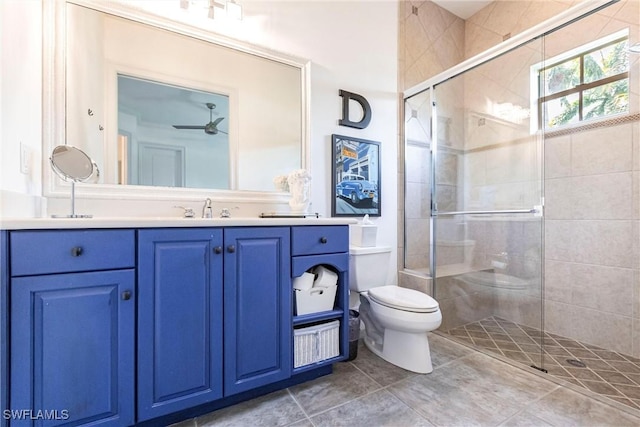 bathroom featuring a shower stall, toilet, vanity, and a ceiling fan