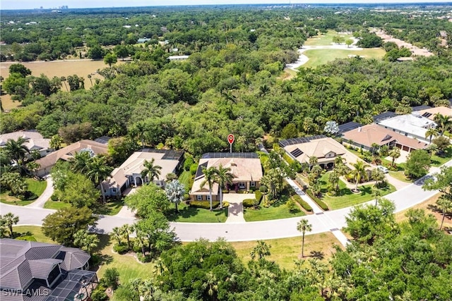 aerial view featuring a forest view and a residential view