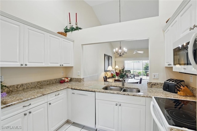 6103 Thresher Dr Unit 102, Naples, FL 34112 - kitchen with white appliances, a chandelier, white cabinets, lofted ceiling, and light stone counters