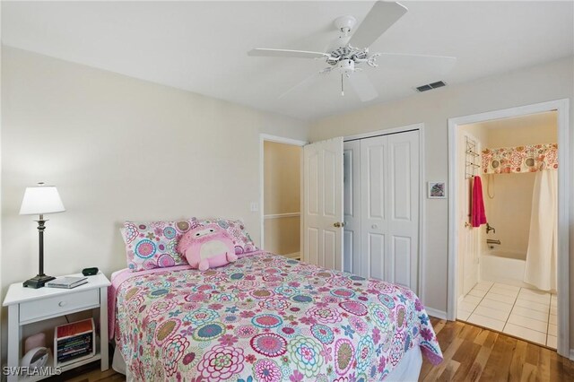 6103 Thresher Dr Unit 102, Naples, FL 34112 - bedroom with wood finished floors, a closet, ceiling fan, and ensuite bath
