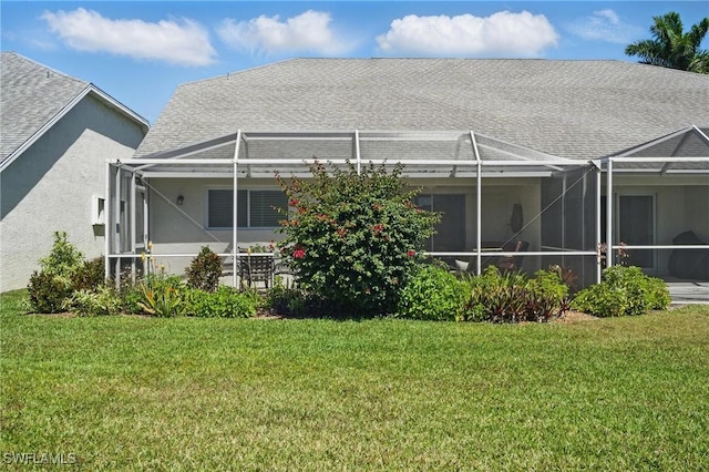 6103 Thresher Dr Unit 102, Naples, FL 34112 - rear view of house with a lawn, stucco siding, a lanai, and a shingled roof