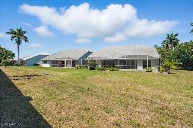 6103 Thresher Dr Unit 102, Naples, FL 34112 - rear view of house with a yard and a lanai