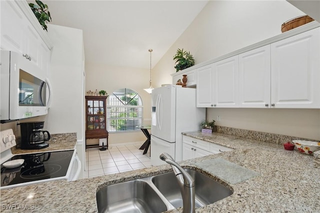 6103 Thresher Dr Unit 102, Naples, FL 34112 - kitchen with white appliances, vaulted ceiling, white cabinets, light tile patterned floors, and light stone counters