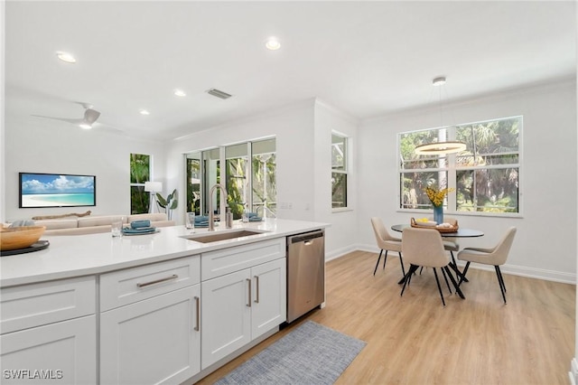 kitchen with light countertops, a sink, white cabinetry, dishwasher, and visible vents