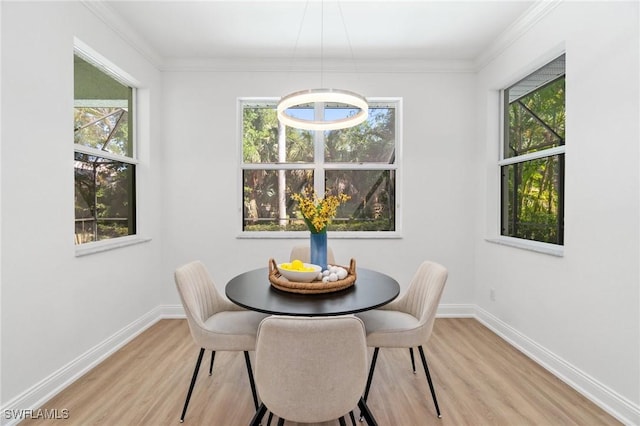 dining area with baseboards, light wood-style floors, and a wealth of natural light