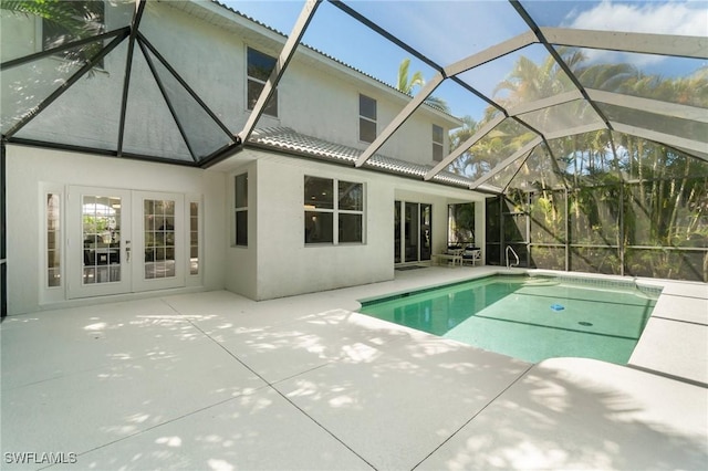 pool with a patio, french doors, and a lanai
