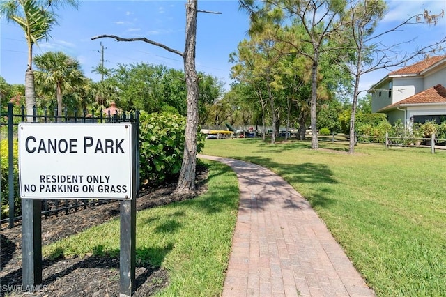 surrounding community featuring fence and a yard