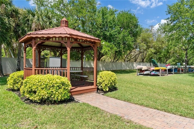 view of property's community featuring a gazebo, fence, and a yard