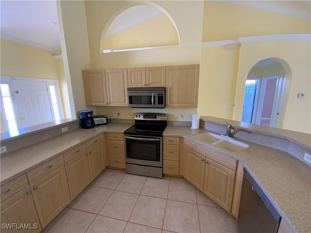 3817 NW 46th St, Cape Coral, FL 33993 - kitchen featuring stainless steel appliances, light brown cabinetry, a sink, a peninsula, and a high ceiling
