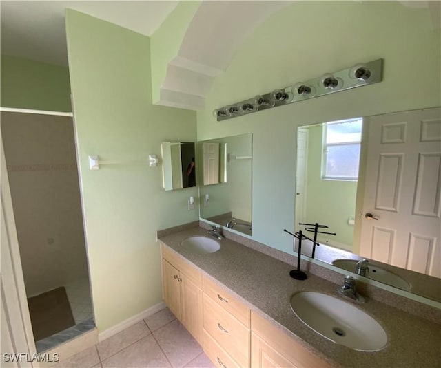 3817 NW 46th St, Cape Coral, FL 33993 - full bathroom with tile patterned flooring, tiled shower, double vanity, and baseboards