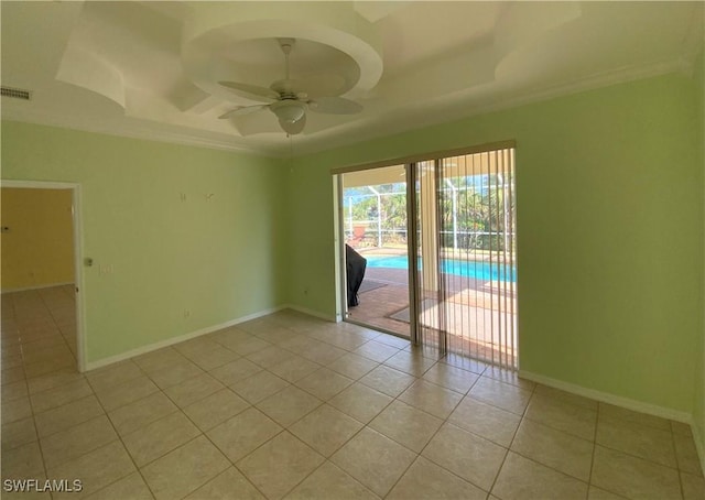 3817 NW 46th St, Cape Coral, FL 33993 - spare room featuring a tray ceiling, light tile patterned floors, a ceiling fan, crown molding, and baseboards
