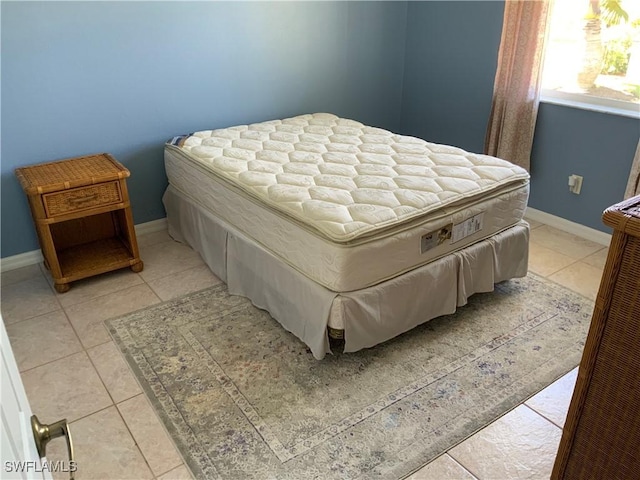 3817 NW 46th St, Cape Coral, FL 33993 - bedroom with baseboards and light tile patterned floors