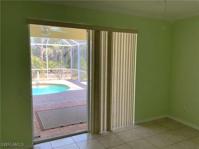 3817 NW 46th St, Cape Coral, FL 33993 - doorway to outside with tile patterned floors, baseboards, and a ceiling fan