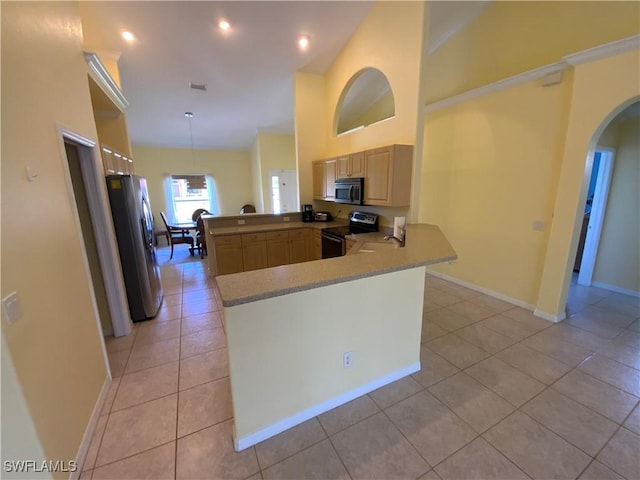 3817 NW 46th St, Cape Coral, FL 33993 - kitchen with stainless steel appliances, a peninsula, light brown cabinetry, light tile patterned floors, and arched walkways