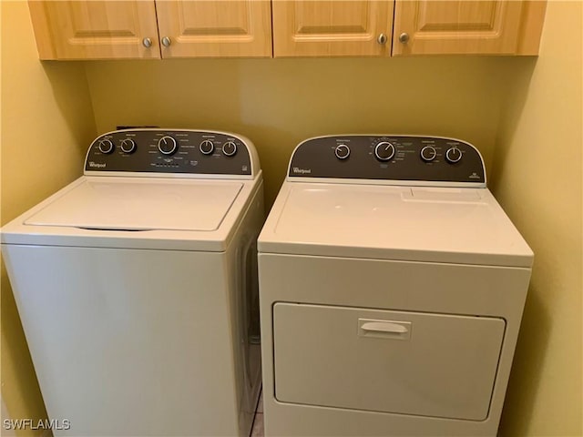 3817 NW 46th St, Cape Coral, FL 33993 - clothes washing area with washing machine and dryer and cabinet space