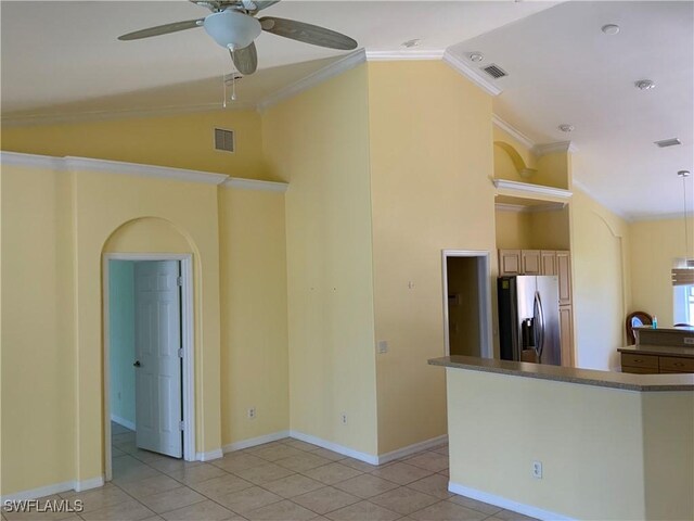 3817 NW 46th St, Cape Coral, FL 33993 - spare room featuring ceiling fan, crown molding, vaulted ceiling, light tile patterned floors, and baseboards