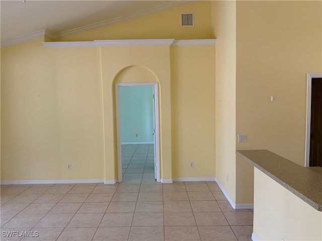 3817 NW 46th St, Cape Coral, FL 33993 - empty room with light tile patterned floors, ornamental molding, lofted ceiling, and baseboards