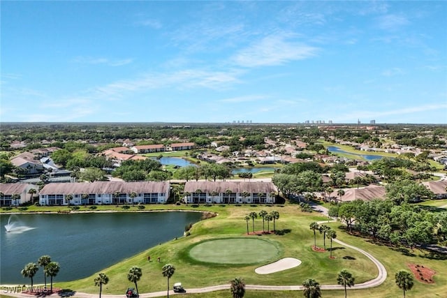 aerial view with golf course view, a residential view, and a water view