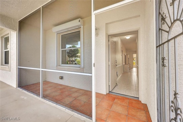 property entrance featuring stucco siding