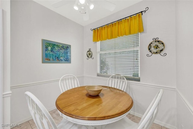 dining room with decorative columns, light tile patterned floors, baseboards, and ceiling fan