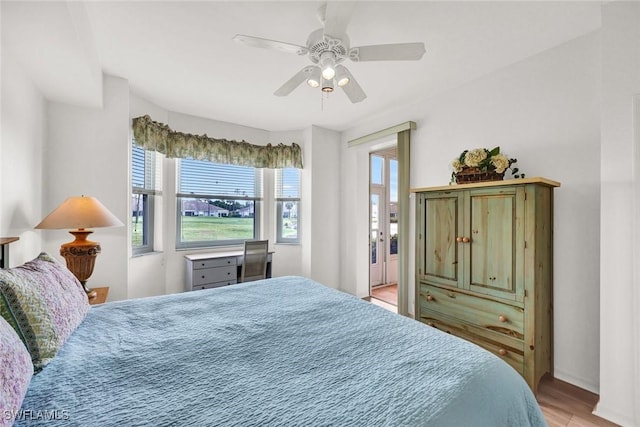 bedroom with light wood-style floors and a ceiling fan