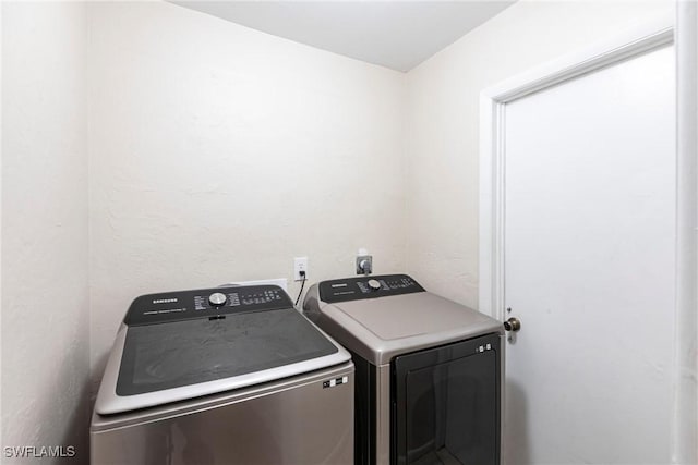 laundry room with washer and dryer and laundry area