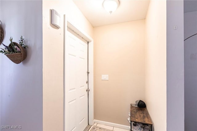entryway featuring light tile patterned flooring and baseboards