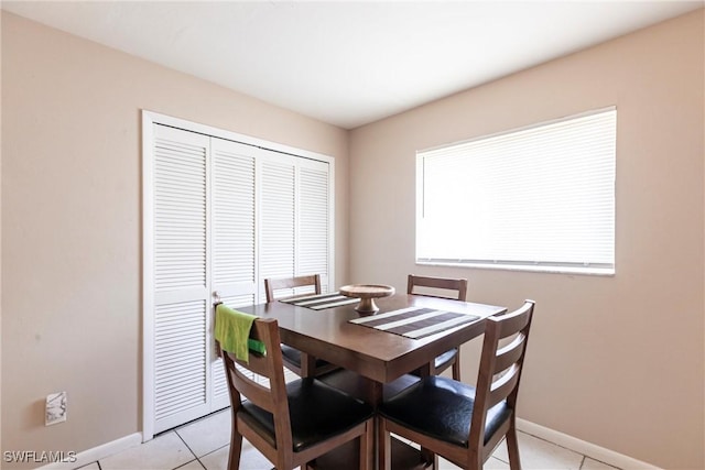 dining room featuring baseboards and light tile patterned floors